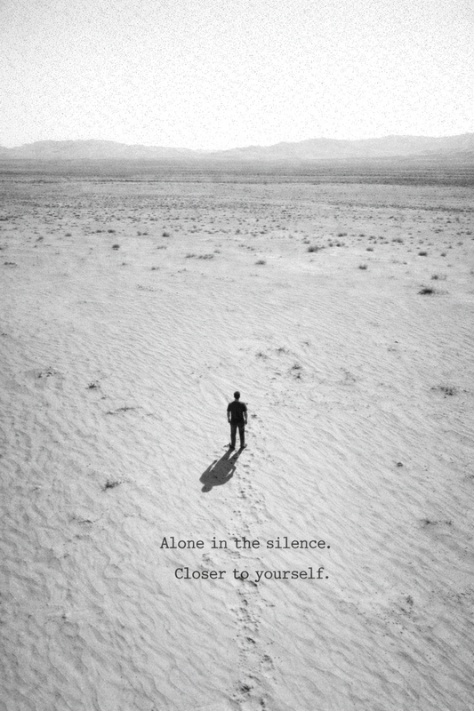 Person walking alone across an empty beach in soft tones, expressing solitude, stillness, and connection with self