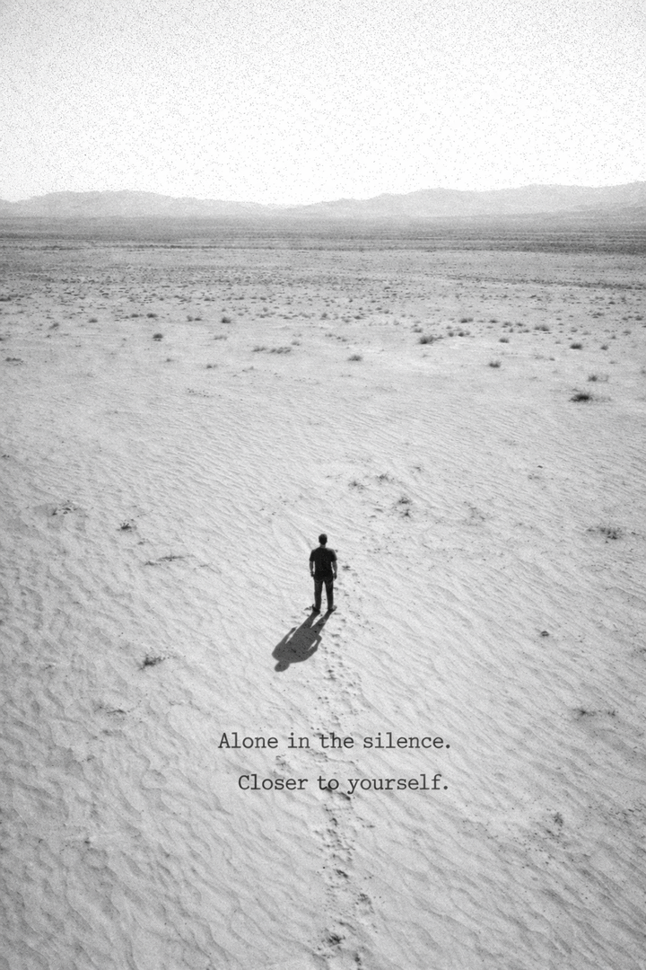 Person walking alone across an empty beach in soft tones, expressing solitude, stillness, and connection with self